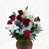 Assortment of red and white florals in a traditional glass vase.