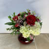 A classic collection of red roses, white hydrangeas and pink charmellia enhanced
