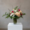 Delicate, airy, and full of charm, this arrangement blends romantic roses, cheerful