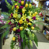 A mixture of Bells of Ireland, dark fuscia carnations, yellow lilies, yellow