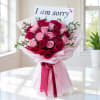 A heartfelt bouquet featuring 24 fresh red and pink roses, delicately accented