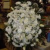 A mixture of white carnations, white roses, white cushion mums, white lilies