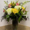 Vased arrangement including magnum mums, yellow daisies, roses, snap dragons, 
solidago, hypericum