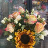 This beautiful arrengment is made of sunflower,light orange roses ,and some mini