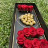 Box with roses and heart chocolate
