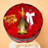 This breathtaking round arrangement blends radiant red roses with a celebratory champagne