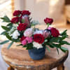 Modern elegance with a hint of tropical added in.  Roses, carnations