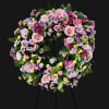 This lush sympathy wreath features an elegant blend of roses, lisianthus, chrysanthemums
