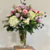 This gorgeous arrangement of tulips, roses and lush green hydrangeas in beautiful