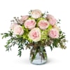 A beautiful combination of a a dozen light pink roses nestled in