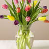 Brighten their day, literally and figuratively, with tulips in a rainbow of
