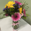 This cheerful mixed flower arrangement brings together a lively assortment of textures
