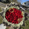 exclusive bouquet of deep red roses, framed with delicate baby&rsquo;s breath and