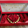 An elegant floral box designed with fresh red roses that spell out