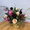 A seductive mix of peonies, ranunculus, mini calla lilies, dendrobium orchids and