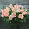 Two dozen roses with lush greens in a bowl vase. For specific