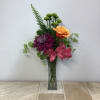 This bright and cheerful bud vase arrangement features a vibrant mix of