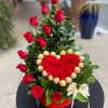 12 roses , red carnations and greens , include 18 ferrero rocher