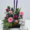 Bright purple and pink sympathy spray. Includes cross stone. 