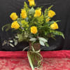 Bright and cheerful, this arrangement of a dozen yellow roses radiates warmth