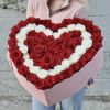Luxury heart-shaped rose box featuring 75 premium red and white roses.
An elegant