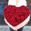 Luxury heart-shaped rose box featuring 75 premium red and white roses.
An elegant