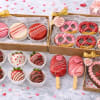 A dreamy Valentine&rsquo;s bundle filled with artisan sweets, featuring chocolate-covered strawberries, cake