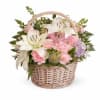 A charming garden-style basket filled with soft pastel blooms, fresh greenery, and
