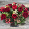 One Dozen red roses, accented with beautiful greenery, &amp; berries....low &amp; lush.
