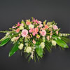 The soft peach colors of roses, gerbera daisies, Asiatic lilies, and stock