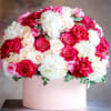 This arrangement features a lush mix of roses and hydrangeas in shades