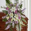 Convey heartfelt condolences with this elegant standing spray, featuring a soothing array
