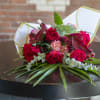 Beautiful red blooms, Gerber daisy, Rose, Carnation with winter greens leyland pine