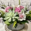 A unique floral arrangement where succulent blooms are utilized alongside cymbidium orchids