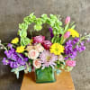 A mixture of colorful spring blooms in a glass vase. Flowers and