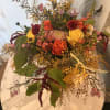 Golden Harvest Garden is a lush, garden-style floral arrangement designed with premium