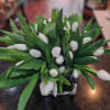 50 stunning tulips in a leaf wrapped glass vase.
Please specify your desired