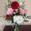 Celebrate Valentine&rsquo;s Day with this red and pink arrangement of gerbera daisies