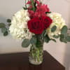 White hydrangea with red roses being accented