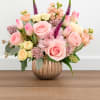 Delicate and charming, Little Princess features blush roses, tulips, hydrangea, and pastel