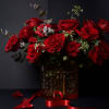 This striking arrangement showcases lush red roses arranged in a full, elegant