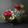 This modern ikebana arrangement highlights bold, textural blooms arranged with intention and