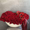 A bold and passionate arrangement where velvety red roses meet striking red