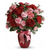 A delightful arrangement of  vibrant red rose and soft pink carnations