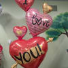 A stunning 65-inch balloon arrangement featuring layered heart balloons with loving messages