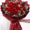 2 dozen deep red roses surrounded by soft white blossoms and fresh