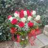 A timeless bouquet of rich red and soft ivory roses, delicately accented