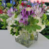Velvety purple flowers nestled among fresh white blooms create a calm and