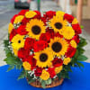 Red roses, spray yellow roses, sunflowers, carnations, babies-breath. Heart shaped arrangement, in