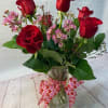 Send your loved one 6 beautifully arranged red roses with some Valentine's